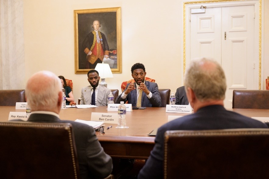 Mayor Brandon M. Scott at table discussing matters